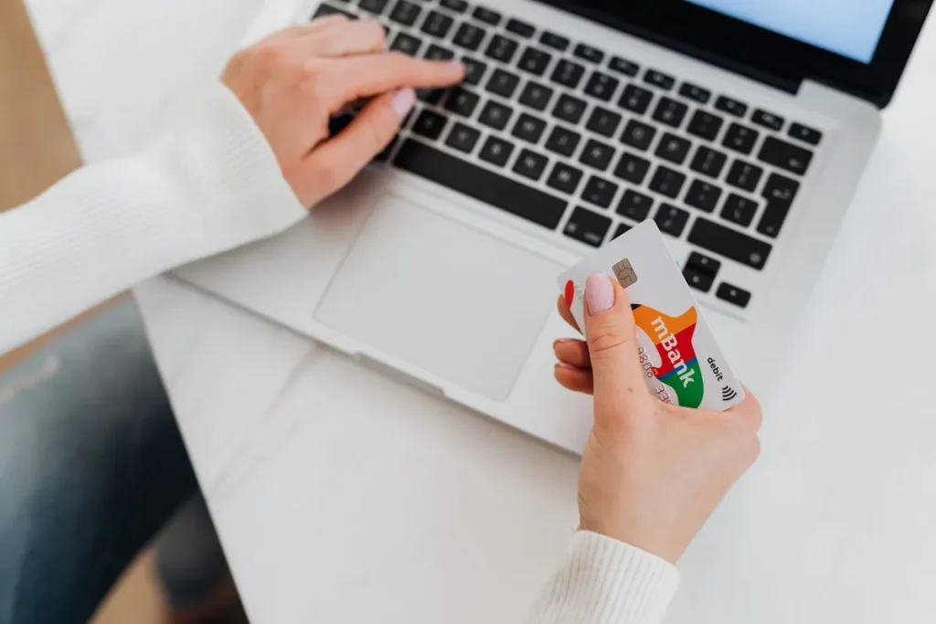 WooCommerce VAT UAE setup: online shopper with a credit card at a laptop