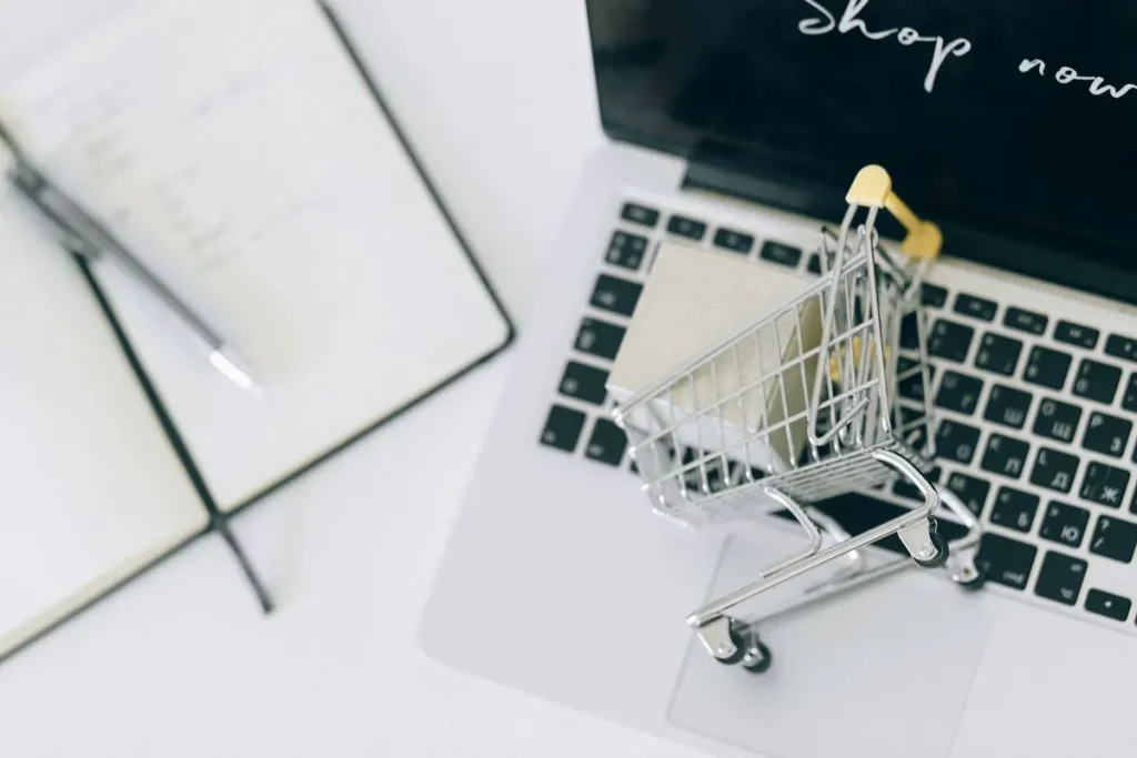 WooCommerce product page SEO: a small shopping cart on a laptop keyboard