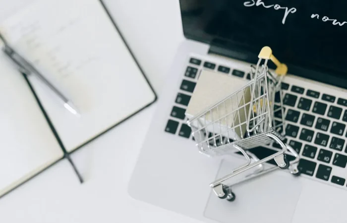 WooCommerce product page SEO: a small shopping cart on a laptop keyboard